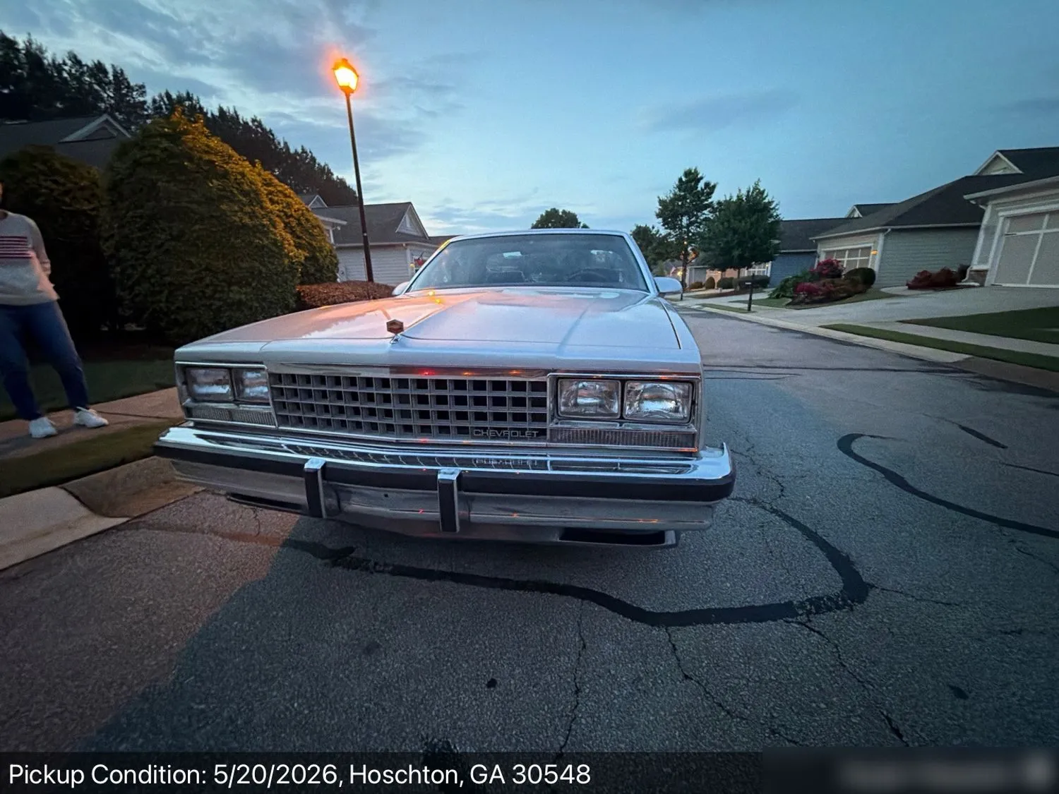 A silver 1980s Chevrolet El Camino at dusk pickup in a Hoschton, Georgia neighborhood