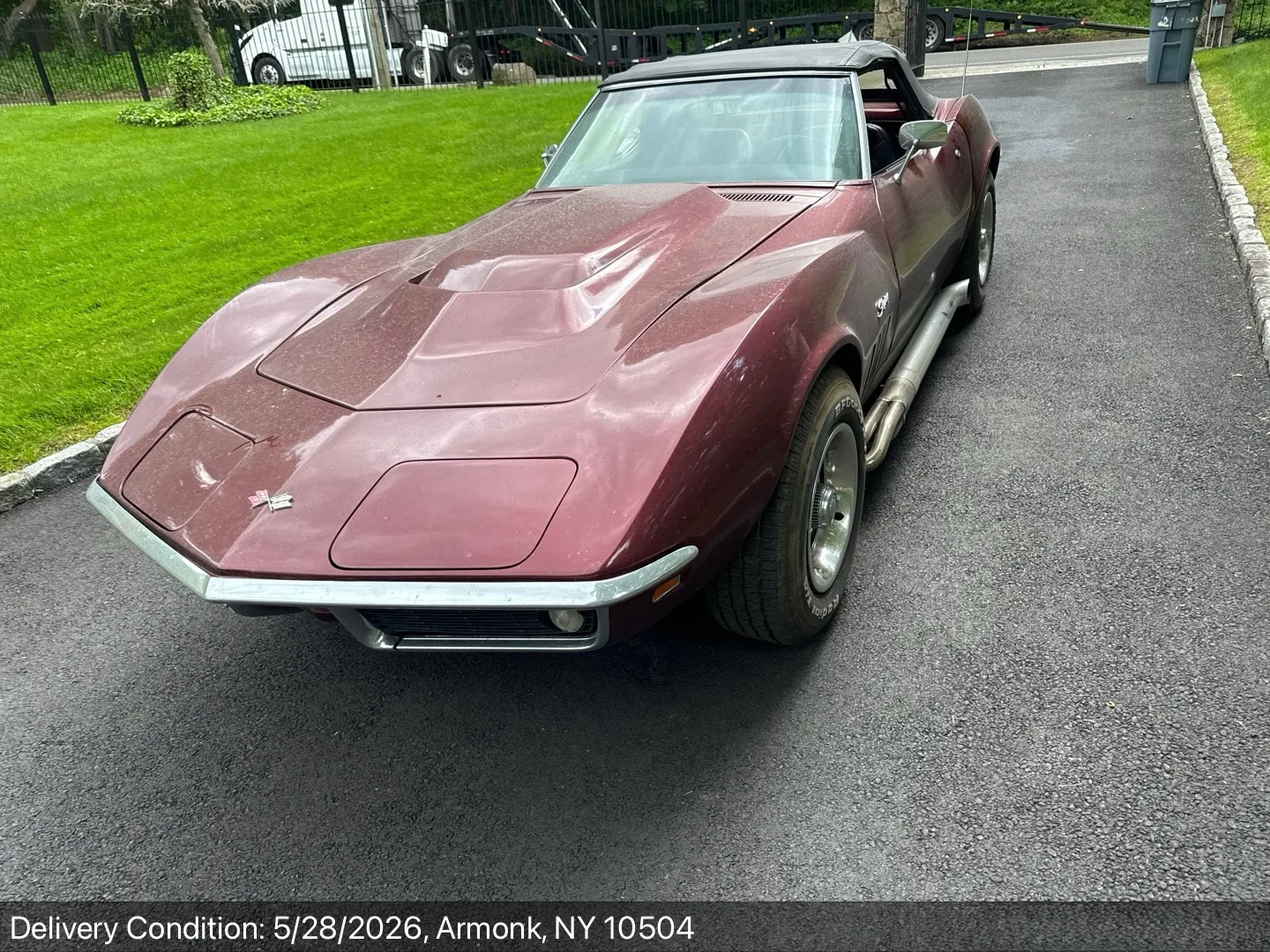 Classic maroon C3 Chevrolet Corvette Stingray convertible delivered in the driveway of a home in Armonk, New York