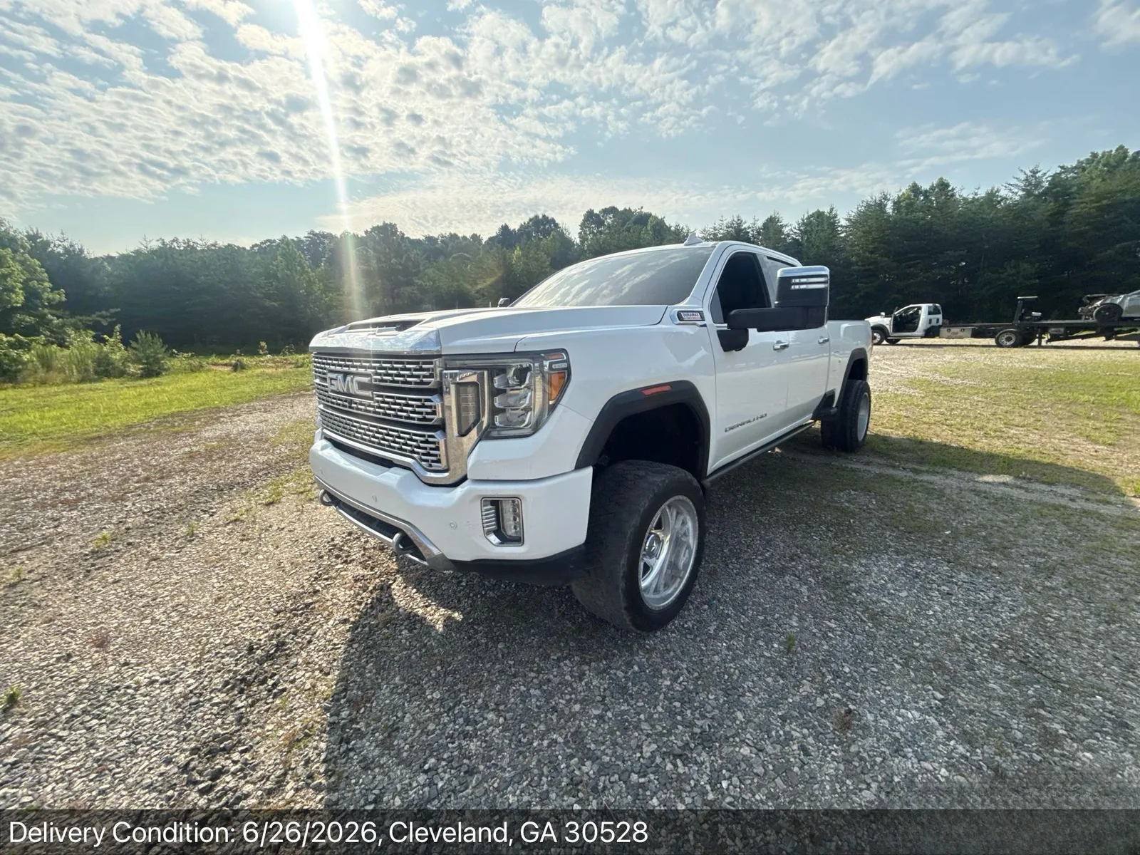 Lifted GMC Sierra Denali HD dually on oversize tires delivered door-to-door in Cleveland, Georgia