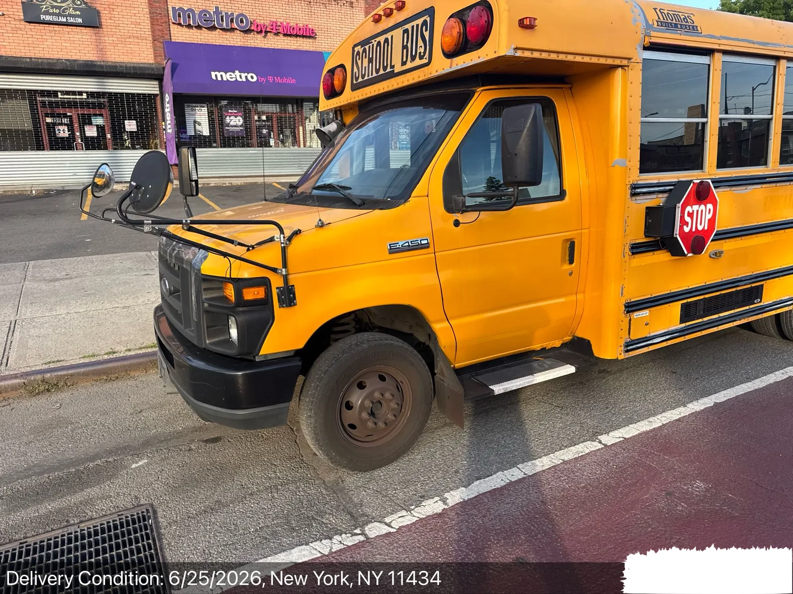 Short yellow school bus delivered curbside in the New York City area