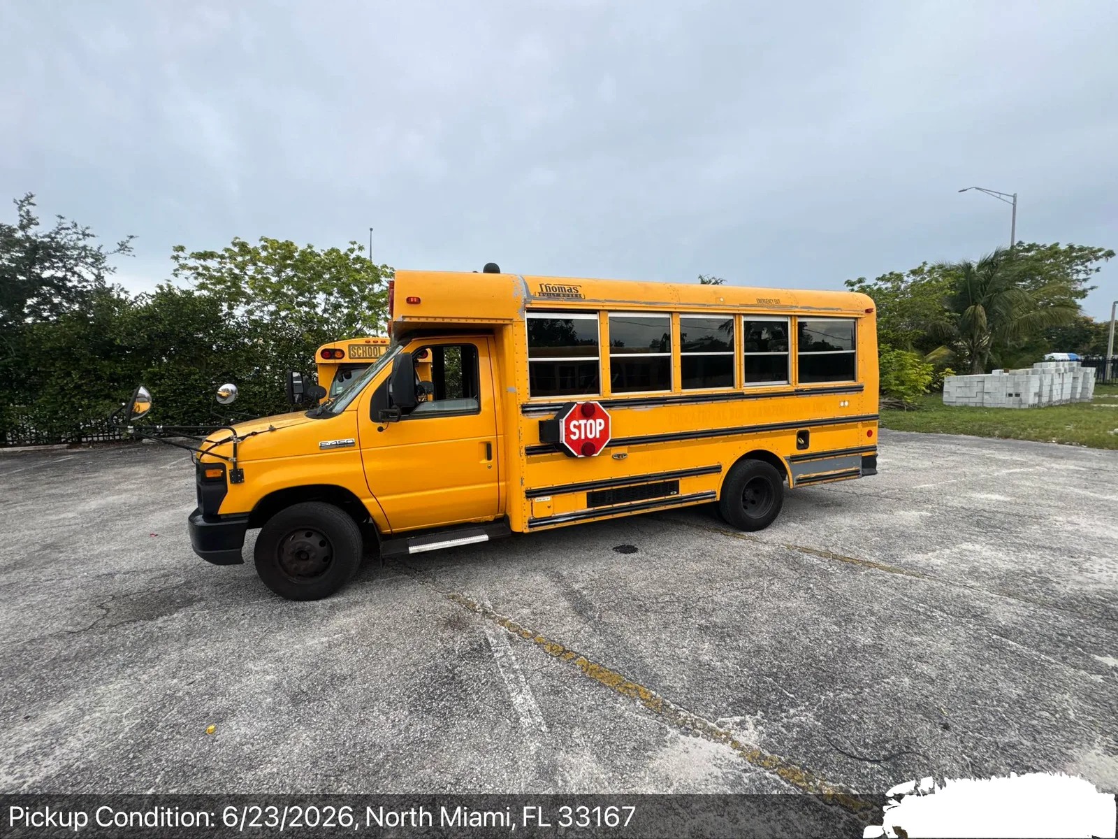 Short yellow Type A school bus at pickup-condition inspection in North Miami, Florida